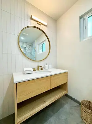 a bathroom with a sink and a mirror at SummerLillie #1 in Summerland