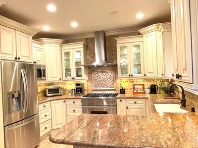 a kitchen with white cabinets and stainless steel appliances at CASA LUX MONICA Prime Santa Monica Luxury Home ONE-OF-A-KIND in Los Angeles