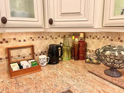a kitchen counter with bottles and a picture on it at CASA LUX MONICA Prime Santa Monica Luxury Home ONE-OF-A-KIND in Los Angeles