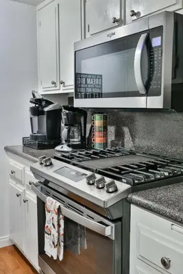 a kitchen with a stove top oven with a microwave at Spa Steps to Lift Private Spa BBQ Massage Chair in Big Bear Lake