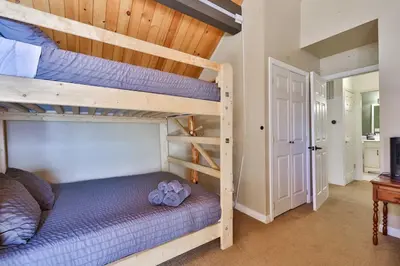 a bedroom with two bunk beds in a room at Spa Steps to Lift Private Spa BBQ Massage Chair in Big Bear Lake