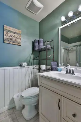 a bathroom with a toilet and a sink and a mirror at Spa Steps to Lift Private Spa BBQ Massage Chair in Big Bear Lake