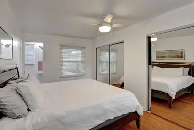 a white bedroom with two beds and a ceiling fan at Hollywood-Sign Griffith-Observatory & Park Kng Bed in Los Angeles