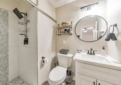 a bathroom with a toilet and a sink and a mirror at Charming pet friendly family getaway Santa Clarita in Santa Clarita