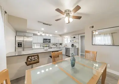 a kitchen with a glass table and a ceiling fan at Charming pet friendly family getaway Santa Clarita in Santa Clarita