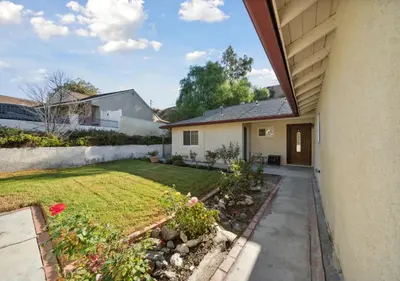 a backyard view of a house with a garden at Charming pet friendly family getaway Santa Clarita in Santa Clarita