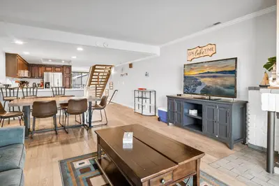 a living room with a couch and a table at Lakehouse Retreat - Community Pool, Lake Views and Walk to Village! in Big Bear Lake