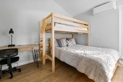 a bedroom with a bunk bed and a desk at Lakehouse Retreat - Community Pool, Lake Views and Walk to Village! in Big Bear Lake