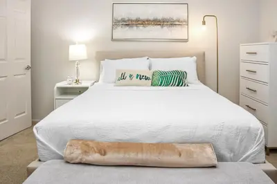 a bedroom with a bed with a white bedspread at Luxe Marina Del Rey Apartment,Parking, Gym, Pool, jacuzzi,BBQ in Los Angeles