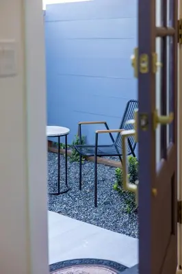 two chairs and a table in front of a door at Hollywood Family Nest in Burbank, Steps to Studios! in Burbank