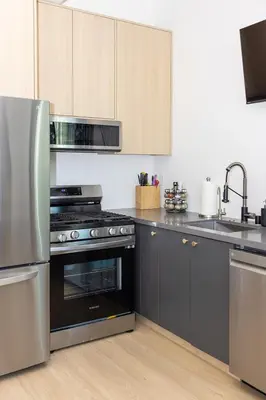 a kitchen with black and stainless steel appliances at Hollywood Family Nest in Burbank, Steps to Studios! in Burbank