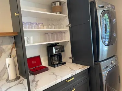 a kitchen with a counter with a coffee maker on a shelf at Guest house with private entry and large pool in Los Angeles