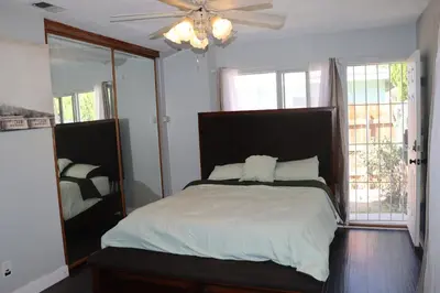 a bedroom with a bed and a ceiling fan at Private Room with Laundry and Pool access in Riverside