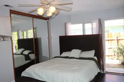 a bedroom with a bed and a ceiling fan at Private Room with Laundry and Pool access in Riverside