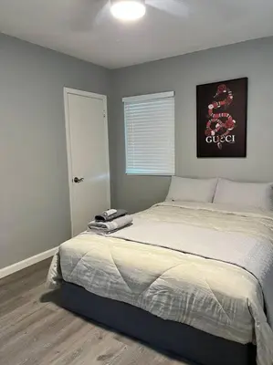 a bedroom with a large bed in a room at Lux Cozy Experience Elegance in San Bernardino