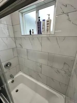 a bathroom with a bath tub and a window at Lux Cozy Experience Elegance in San Bernardino