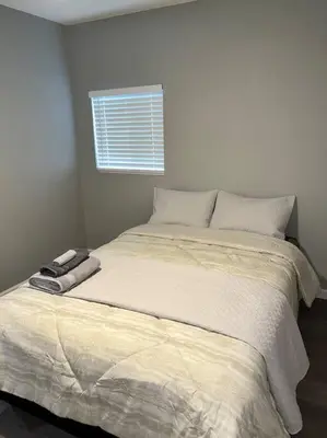 a bedroom with a large bed with a window at Lux Cozy Experience Elegance in San Bernardino