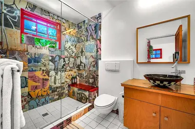 a bathroom with a shower and a sink and a toilet at Artsy Venice Beach Canals Studio w/Rooftop & Sauna in Los Angeles