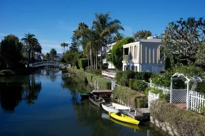a group of boats docked on a river with buildings at Artsy Venice Beach Canals Studio w/Rooftop & Sauna in Los Angeles