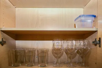 a row of wine glasses sitting on a shelf at Luxury ApartStudio Marina Del Rey Pool, Gym, Parking, Jacuzzi, BBQ in Los Angeles