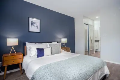 a bedroom with a large bed with a blue wall at Hollywood 1BR w pool nr Griffith Park trails LAX-117 in Los Angeles
