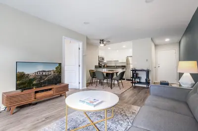 a living room with a couch and a tv and a table at Hollywood 1BR w pool nr Griffith Park trails LAX-117 in Los Angeles