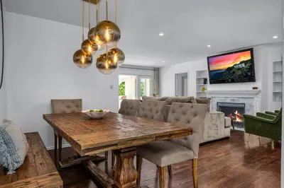 a living room with a table and a fireplace at Sophia's Oasis in Los Angeles