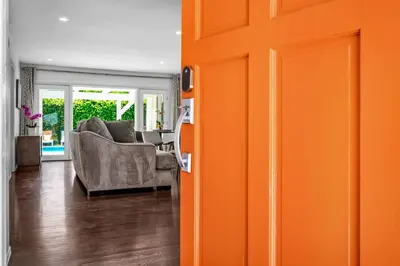 an orange door in a living room with a couch at Sophia's Oasis in Los Angeles