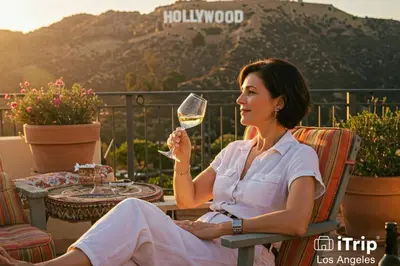 a woman sitting in a chair holding a glass of wine at Sophia's Oasis in Los Angeles