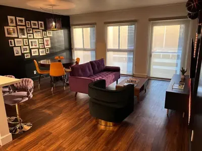 a living room with a purple couch and a table at Downtown LA - Mamba Suite - Free Indoor Parking! in Los Angeles