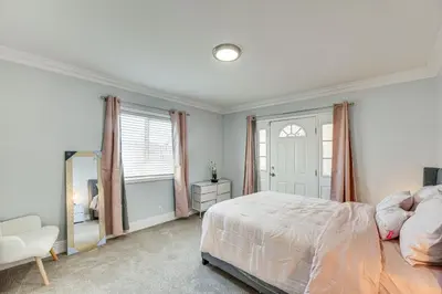 a bedroom with a large bed and a mirror at Furnished Patio! South Central Home 14 Mi to DTLA in Compton