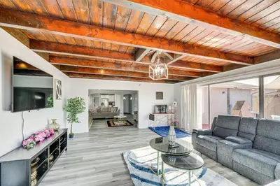 a living room with a couch and a tv at Furnished Patio! South Central Home 14 Mi to DTLA in Compton