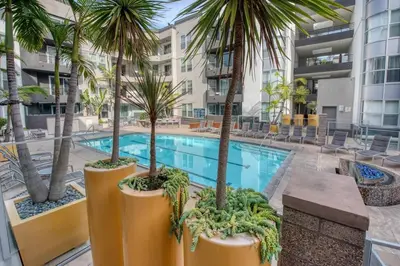 a swimming pool with palm trees and a building at 2 bed in Marina Del Rey- Flash holiday deal! in Los Angeles