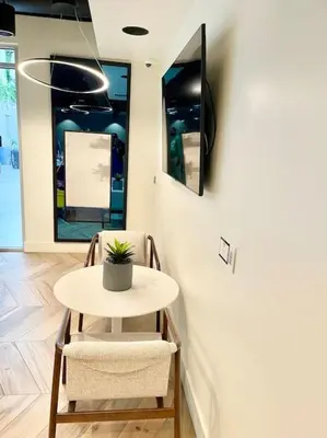 a small table with two chairs and a tv on a wall at 1 bedroom. 2 beds. 1 bath with Balcony in Los Angeles