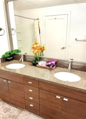 a bathroom with two sinks and a large mirror at 1 bedroom. 2 beds. 1 bath with Balcony in Los Angeles