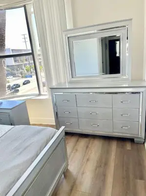 a bedroom with a dresser with a television on it at 1 bedroom. 2 beds. 1 bath with Balcony in Los Angeles