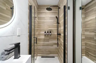 a shower with a glass door in a bathroom at Newly Remodeled Home in the Heart of Orange County in Midway City