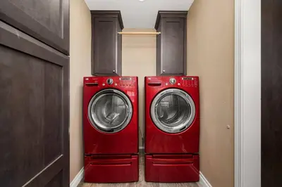 two red washing machines sitting in a room at Newly Remodeled Home in the Heart of Orange County in Midway City