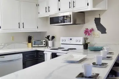 a kitchen with white cabinets and a white counter top at Oakridge Ranch ※ Sequoia, Kern River & Lake Escape in Lake Isabella