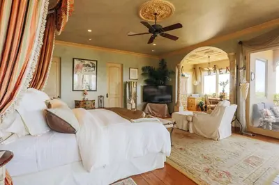 a living room with a white couch and a ceiling fan at Malibu by the Sea - 5-STARS! in Solromar