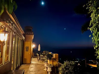 a balcony of a building at night with the moon at Malibu by the Sea - 5-STARS! in Solromar