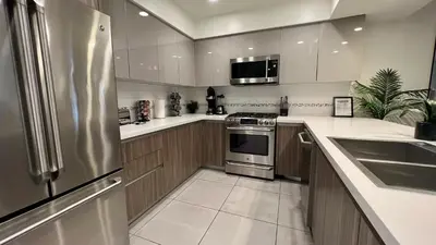 a kitchen with a stainless steel refrigerator and a sink at Century City Cozy 3 Bedroom Apartment with Parking 302,303 in Los Angeles