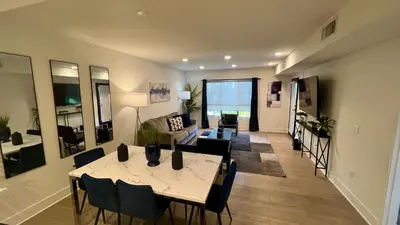 a living room with a table and a couch at Century City Cozy 3 Bedroom Apartment with Parking 302,303 in Los Angeles