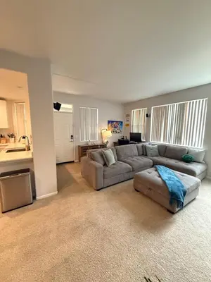 a living room with a couch and a kitchen at Canyon Country Cozy Apartment, Pool and Jacuzzi in Santa Clarita