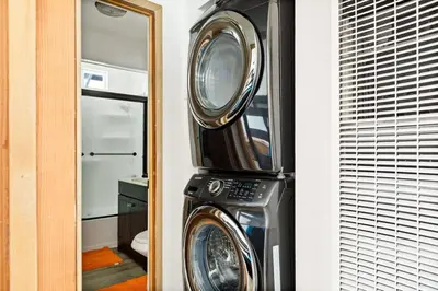 a washer and dryer in a room with a mirror at Lil Oso Bonita Cabin in Big Bear Lake