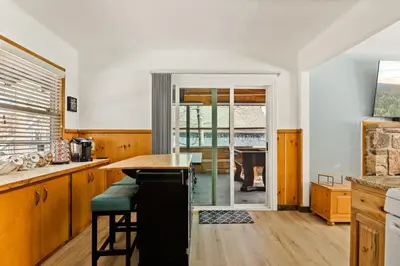 a kitchen with a wooden table and a dining room at Lil Oso Bonita Cabin in Big Bear Lake