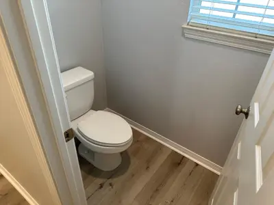 a small bathroom with a toilet and a window at ALE Displaced, Relocation, Insurance, Fire, Flood in Corona