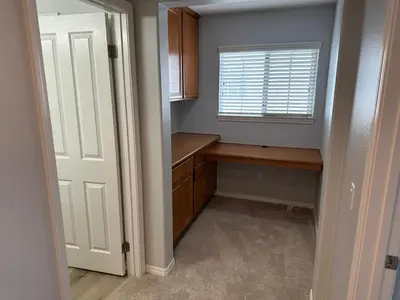 a small kitchen with a desk and a window at ALE Displaced, Relocation, Insurance, Fire, Flood in Corona