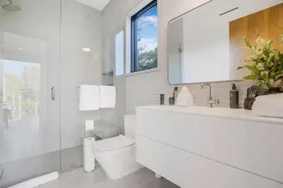 a white bathroom with a toilet and a sink at Levitt Lane in Los Angeles