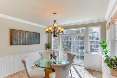 a dining room with a glass table and chairs at Lake Arrowhead Home Mountain View, Walk to Water! in Lake Arrowhead